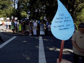 People protesting the Trans Mountain pipeline await the arrival of Prime Minister Justin Trudeau as he visits forestry workers at the B.C. Forest Discover Centre in Duncan, B.C., on Saturday, August 4, 2018.