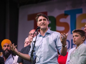 Prime Minister Justin Trudeau delivers remarks on the first day of the Taste of the Danforth street festival in Toronto, on Friday, August 10, 2018.