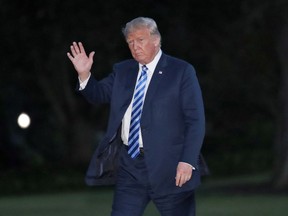 President Donald Trump waves as he walks on the South Lawn of the White House after stepping off Marine One, Monday, Aug. 13, 2018, in Washington.