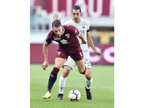 Torino's Andrea Belotti and Roma's Javier Pastore, back, vie for the ball during the Serie A soccer match between Torino and Roma at the Turin Olympic Stadium, Italy, Sunday, Aug. 19, 2018.