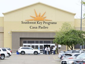 FILE - In this June 18, 2018, file photo, dignitaries take a tour of Southwest Key Programs Casa Padre, a U.S. immigration facility in Brownsville, Texas, where children are detained. When school leaders in San Benito, Texas, learned of an influx of children to a migrant shelter in town, they felt obliged to help. The superintendent reached out and agreed to send 19 bilingual teachers and hundreds of computers to make the learning environment as similar as possible to one of his schools.