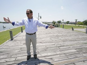 Resident Engineer Steve Sherrill, with the US Army Corps of Engineers, talks about the project to raise some of the levees and seawalls in the area Thursday, July 26, 2018, in Port Arthur, Texas.  As the nation plans new defenses against the more powerful storms and higher tides expected from climate change, one project stands out: an ambitious proposal to build a nearly 60-mile "spine" of concrete seawalls, earthen barriers, floating gates and steel levees on the Texas Gulf Coast.
