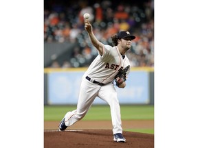 Houston Astros starting pitcher Gerrit Cole throws to a Colorado Rockies batter during the first inning of a baseball game Wednesday, Aug. 15, 2018, in Houston.