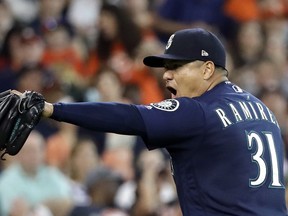 Seattle Mariners starting pitcher Erasmo Ramirez reacts after his team turned a double play to end the fifth inning of a baseball game against the Houston Astros, Sunday, Aug. 12, 2018, in Houston.