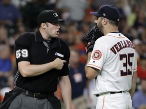 Houston Astros starting pitcher Justin Verlander (35) talks with home plate umpire Nic Lentz (59) after being called for a balk during the second inning of the team's baseball game against the Seattle Mariners on Thursday, Aug. 9, 2018, in Houston.