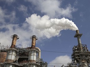 In this March 29, 2018, photo, steam is released out of the Valero Refinery in Houston. More than a year after Hurricane Harvey slammed into the Texas coast, state environmental authorities have only just begun enforcement actions against a handful of companies deemed responsible for some of the most massive air and water pollution incidents reported during and immediately after the storm.