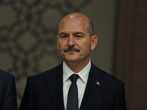 In this Monday, July 9, 2018 file photo, Suleyman Soylu, Turkey's interior minister, listens to President Recep Tayyip Erdogan presenting his new cabinet during a news conference at the Presidential Palace in Ankara, Turkey.