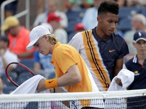 Denis Shapovalov, left, passes in front of countryman Felix Auger-Aliassime during their first-round match at the U.S. Open on Aug. 27.