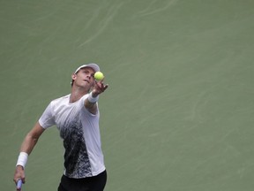 Kevin Anderson, of South Africa, serves to Denis Shapovalov, of Canada, during the third round of the U.S. Open tennis tournament, Friday, Aug. 31, 2018, in New York.