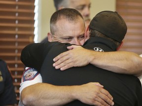 Draper Battalion Chief Bart Vawdrey hugs a fellow firefighter during a press conference in Draper, Utah, on Tuesday, Aug. 14, 2018. Draper Battalion Chief Matthew Burchett was killed on Monday night while fighting the largest blaze in California history, the Mendocino Complex fire north of San Francisco.