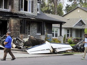 Federal Aviation Administration officials investigate the scene of a plane crash in Payson, Utah on Monday, Aug. 13, 2018. Authorities say the small plane has crashed into a house in Utah, killing the pilot.