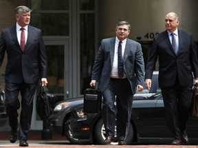 Members of the defense team for Paul Manafort, including Kevin Downing, left, Richard Westling, and Thomas Zehnle, walk to federal court as the trial of the former Trump campaign chairman continues, in Alexandria, Va., Monday, Aug. 13, 2018. The prosecution is expected to rest its case in the fraud trial.