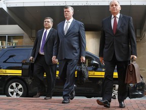 Defense attorneys Richard Westling, left, Kevin Downing, and Thomas Zehnle, walk to federal court as jury deliberations begin in the trial of former Trump campaign chairman Paul Manafort, in Alexandria, Va., Thursday, Aug. 16, 2018.