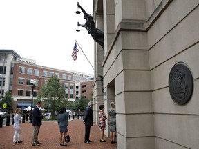 Members of the media wait in line to enter federal court as jury deliberations continue in the trial of former Donald Trump campaign chairman Paul Manafort, in Alexandria, Va., Tuesday, Aug. 21, 2018.