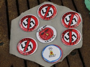 A vendor displays wares on the mall as State Police lock down the downtown area in anticipation of the anniversary of last year's Unite the Right rally in Charlottesville, Va., Saturday, Aug. 11, 2018. The Governor has declared a state of emergency in Charlottesville.