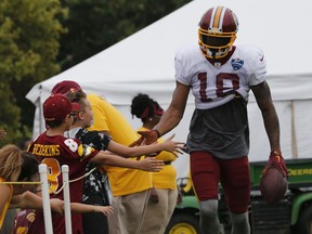Washington Redskins wide receiver Josh Doctson slaps hands with fans during the morning session at NFL football training camp in Richmond, Va., Wednesday, Aug. 1, 2018.