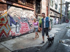 Trey Helten, right, speaks with drug user Gina McEwen while walking his dog Princess Zelda in the Downtown Eastside of Vancouver on Friday, August 10, 2018. Helten has known almost every one of the 50 or so people he has treated for overdoses on Vancouver's Downtown Eastside since February. As a former heroin and methamphetamine user who lived in the neighbourhood for three years before getting clean and returning "to do something positive," he's one of many peer support volunteers and workers playing a vital role in stemming the overdose crisis that has devastated the province.