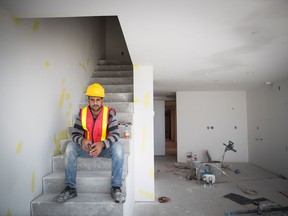 Hasan Alsheblak, a Syrian refugee who started a floor tiling business in Canada, poses for a photograph during a break from working at a condo tower under construction in Richmond, B.C., on Tuesday July 31, 2018. Alsheblak arrived in Canada via Jordan in December 2016 a few years after a missile destroyed his house in Syria.