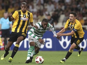 AEK Athens' Alef, left, and AEK Athens' Andre Simoes, right, chase down Celtic's Olivier Ntcham, center, during a Champions League third qualifying round, second leg, soccer match between AEK Athens and Celtic at the Olympic stadium in Athens, Tuesday, Aug. 14, 2018.