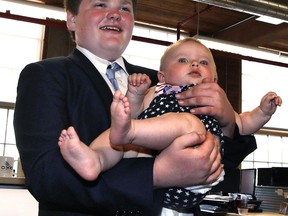 Vermont Democratic gubernatorial candidate Ethan Sonneborn, who is a 14-year old student, holds up eight-month-old Brooklin Yanus during his election night party in Winooski, Vt., Tuesday, Aug. 14, 2018. Sonneborn has taken advantage of a quirk in state law that doesn't require gubernatorial candidates to be registered voters.