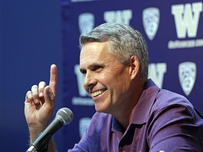 Washington NCAA college head football coach Chris Petersen points skyward in response to hearing Blue Angels jets soar nearby as he speaks at a news conference Thursday, Aug. 2, 2018, in Seattle. Petersen hates expectations, so he's likely loathing Washington being the overwhelming favorite in the Pac-12 and likely top 10 when the preseason AP poll comes out. The Huskies open fall camp on Friday in preparation for the Sept. 1 opener against Auburn.
