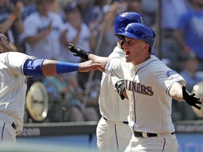 Seattle Mariners' Kyle Seager, right, runs into the arms of Nelson Cruz after Seager's home run against the Toronto Blue Jays in the seventh inning of a baseball game Sunday, Aug. 5, 2018, in Seattle.