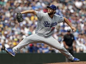 Los Angeles Dodgers starting pitcher Clayton Kershaw throws against the Seattle Mariners in the first inning of a baseball game Sunday, Aug. 19, 2018, in Seattle.