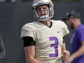 Washington quarterback Jake Browning stands on the field during an NCAA college football practice Friday, Aug. 10, 2018, in Seattle. For the first time in more than 20 years, Washington will go into a season with a legitimate belief that being in the national championship conversation doesn't sound foolish. They are the clear choice fin the Pac-12 North and to win the Pac-12 title. Accomplish both of those and there's a good chance the Huskies could find themselves in the College Football Playoff for the second time in three years.