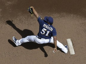 Milwaukee Brewers starting pitcher Freddy Peralta throws during the first inning of a baseball game against the Cincinnati Reds Wednesday, Aug. 22, 2018, in Milwaukee.