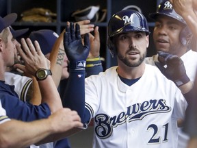 Milwaukee Brewers' Travis Shaw is congratulated after hitting a grand slam during the first inning of a baseball game against the Colorado Rockies Saturday, Aug. 4, 2018, in Milwaukee.