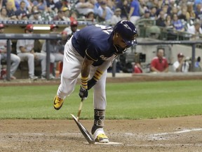 Milwaukee Brewers' Orlando Arcia breaks his bat after striking out to end the eighth inning of a baseball game against the Cincinnati Reds Tuesday, Aug. 21, 2018, in Milwaukee.