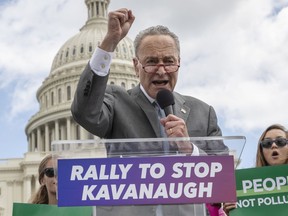 FILE - In this Aug. 1, 2018 file photo, Senate Minority Leader Chuck Schumer, D-N.Y., joins protesters objecting to President Donald Trump's Supreme Court nominee Brett Kavanaugh at a rally Capitol in Washington.  Schumer, who plans to meet Kavanaugh privately early this week, is methodically building arguments that would help vulnerable Democratic senators in Trump-loving states vote "no," while avoiding explicitly pressuring them. But the party's restive left-wing says he's not aggressively rallying Democratic lawmakers to oppose the nomination, inhibiting the momentum needed to galvanize voters and maybe even win the uphill fight.