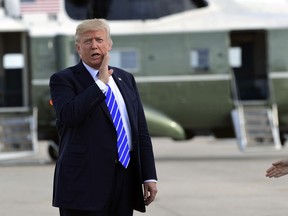 FILE - In this Sept. 26, 2017, file photo, President Donald Trump responds to a reporter's question on health care after arriving at John F. Kennedy International Airport in New York. Trump says insurers are "going wild" about his new health care options and "millions and millions" of people will be signing up. But insurance companies say it will take time to design new plans and get approval from state regulators, and two major industry groups have actually expressed concern about potential downsides for consumers.