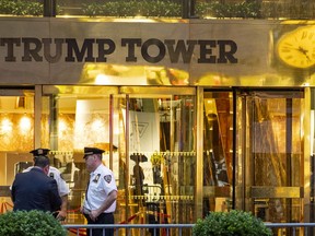 In this July 27, 2018 photo, police investigate the report of a "suspicious item" inside Trump Tower on Fifth Avenue, in New York.   AP explains why the Trump Tower meeting matters in the Mueller probe.