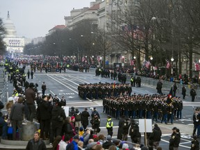 FILE - In this Jan. 20, 2017, file photo, military units participate in the inaugural parade from the Capitol to the White House in Washington, Friday, Jan. 20, 2017. A U.S. official says the 2018 Veterans Day military parade ordered up by President Donald Trump would cost about $92 million _ more than three times the maximum initial estimate.