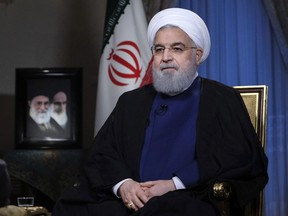 In this photo released by official website of the office of the Iranian Presidency, President Hassan Rouhani addresses the nation in a televised speech in Tehran, Iran, Monday Aug. 6, 2018. The U.S. is bracing for cyberattacks Tehran could launch in retaliation for sanctions President Donald Trump has slapped back on Iran, cybersecurity and intelligence experts warn (Iranian Presidency Office via AP)