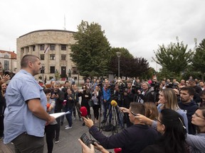 Bosnian journalists gather at the main square in Banja Luka, Bosnia, Monday, Aug. 27, 2018, to protest against an attack on a journalist. The U.S. embassy in Bosnia and the country's journalists have expressed outrage after unknown assailants beat up and seriously hurt reporter Vladimir Kovacevic of an independent television station BNTV, late night on Sunday outside his home in Banja Luka, the main town in the Serb-run part of Bosnia.