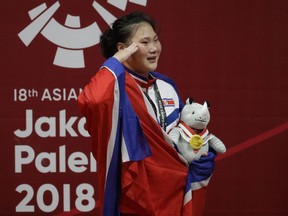 Gold medalist North Korea's Kim Hyo Sim breaks in tears during ceremonies at the women's 63kg weightlifting at the 18th Asian Games in Jakarta, Indonesia, Friday, Aug. 24, 2018.