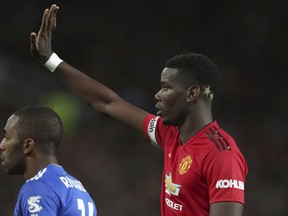 Manchester United's Paul Pogba, gestures to a teammates and who has two gold stars colouring the back of his head, a reference to the 2 World Cups that France have won, the during the English Premier League soccer match between Manchester United and Leicester City at Old Trafford, in Manchester, England, Friday, Aug. 10, 2018.