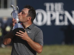 FILE - In this July 22, 2018 file photo Francesco Molinari of Italy kisses the trophy after winning the British Open Golf Championship in Carnoustie, Scotland. When Molinari met elite performance coach Dave Alred at the start of 2016, the Italian golfer was ranked 78th in the world. Fast forward two years and Molinari is now ranked sixth and has won three of his past six tournaments, including last month's British Open.