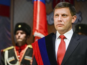 FILE - In this Tuesday, Nov. 4, 2014 file photo, rebel leader Alexander Zakharchenko stands during a swearing in ceremony in Donetsk, Ukraine. The news agency of the Russia-backed separatists fighting in eastern Ukraine's Donetsk region is reporting that separatist leader Alexander Zakharchenko has died in a cafe explosion. Rebel news agency DAN said the Friday, Aug. 31, 2018 explosion tore through a cafe in Donetsk, the region's principal city.