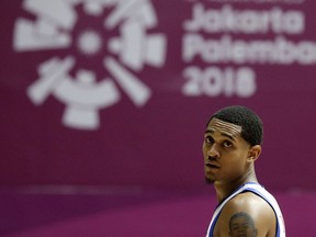 Philippines' Jordan Clarkson watches play during their men's basketball game against China at the 18th Asian Games in Jakarta, Indonesia on Tuesday, Aug. 21, 2018.