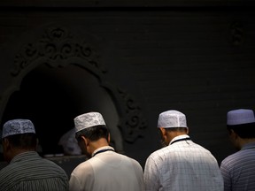 In this July 18, 2015, file photo, Chinese Hui Muslims pray during Eid al-Fitr prayers at Niujie Mosque in Beijing.