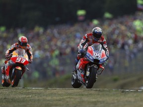 Italian rider Andrea Dovizioso of the Ducati Team, right, steers his motorcycle followed by Spain's rider Marc Marquez of the Repsol Honda Team during the MotoGP race at the Czech Republic motorcycle Grand Prix at the Automotodrom Brno, in Brno, Czech Republic, Sunday, Aug. 5, 2018.