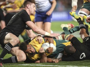 New Zealand's Jodie Barrett fails to stop Australia's Will Genia scoring a try in the Bledisloe Cup rugby test match at Eden Park in Auckland, New Zealand, Saturday Aug. 25, 2018.