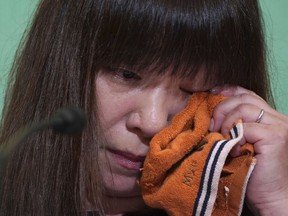 Myu, the wife of missing Japanese freelance journalist Jumpei Yasuda, wipes her tears during a press conference at Japan National Press Club in Tokyo Tuesday, Aug. 7, 2018. Myu told a news conference in Tokyo Tuesday that her husband is no enemy of the Middle East and loves its people. A video released last week showed a captive who the Japanese government said it believes is missing journalist Jumpei Yasuda.