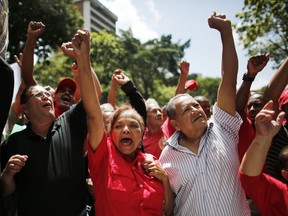 Supporters of Venezuela's President Nicolas Maduro cheer in his favor as they march to the Miraflores Presidential Palace in Caracas, Venezuela, Monday, Aug. 6, 2018. Maduro dodged an apparent assassination attempt over the weekend when drones armed with explosives detonated while he was delivering a speech to hundreds of soldiers being broadcast live on television, according to officials.