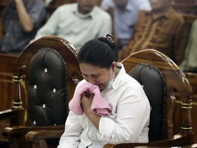 Ethnic Chinese woman Meiliana weeps during her sentencing hearing at a district court in Medan, North Sumatra, Indonesia, Tuesday, Aug. 21, 2018. The court has sentenced Meiliana who complained about a noisy mosque to 18 months in prison for blasphemy.