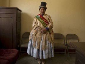 In this June 30, 2018 photo, Escoma Councilwoman Marcela Huanca poses for a photo wearing her official sash, in Escoma, Bolivia. Huanca reported the mayor of her town of Escoma for corruption. After she filed the complaint, the mayor died in a car crash. The family of the mayor blamed her for his death and attacked her.