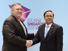 U.S. Secretary of State Mike Pompeo, left, meets Myanmar's Minister of State for Foreign Affairs U Kyaw Tin on the sidelines of the 51st ASEAN Foreign Ministers Meeting in Singapore, Saturday, Aug. 4, 2018.